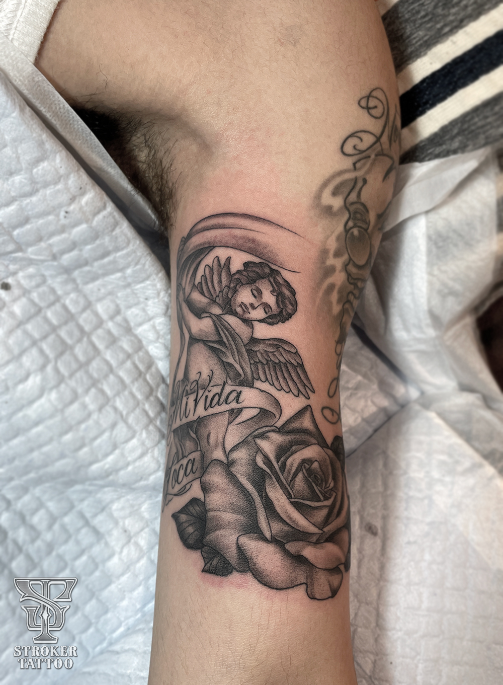 上腕内側に天使と薔薇のタトゥー